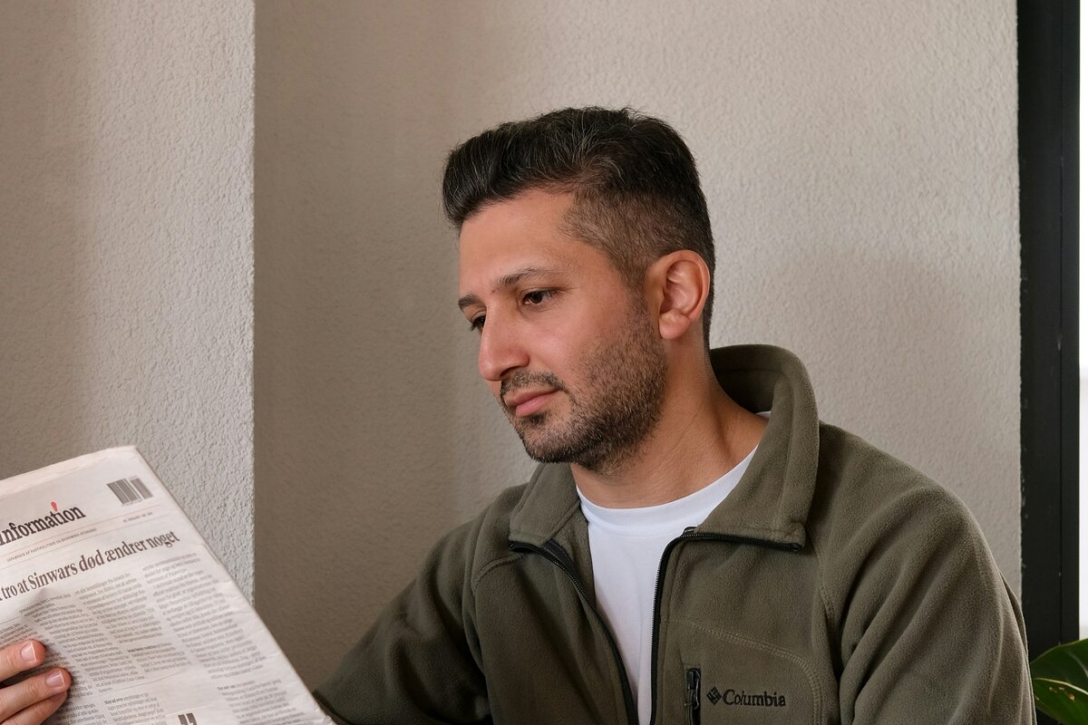 Person reviewing financial documents at a kitchen table